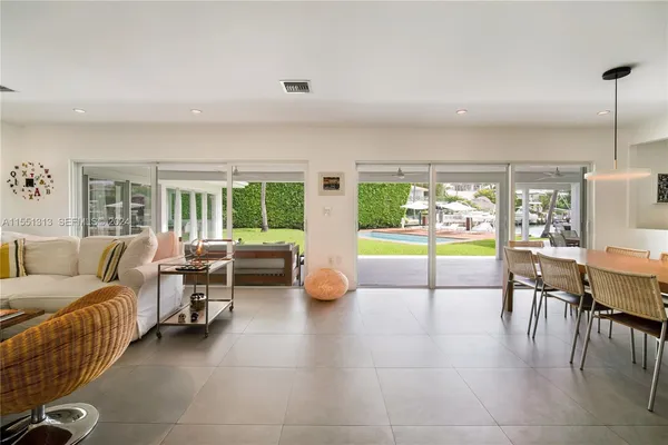 a living room with furniture and a floor to ceiling window