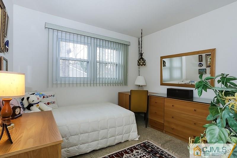 29 Nottingham Road Edison, NJ 08820 - Photo 11 of 18 a bedroom with a bed a table and chair