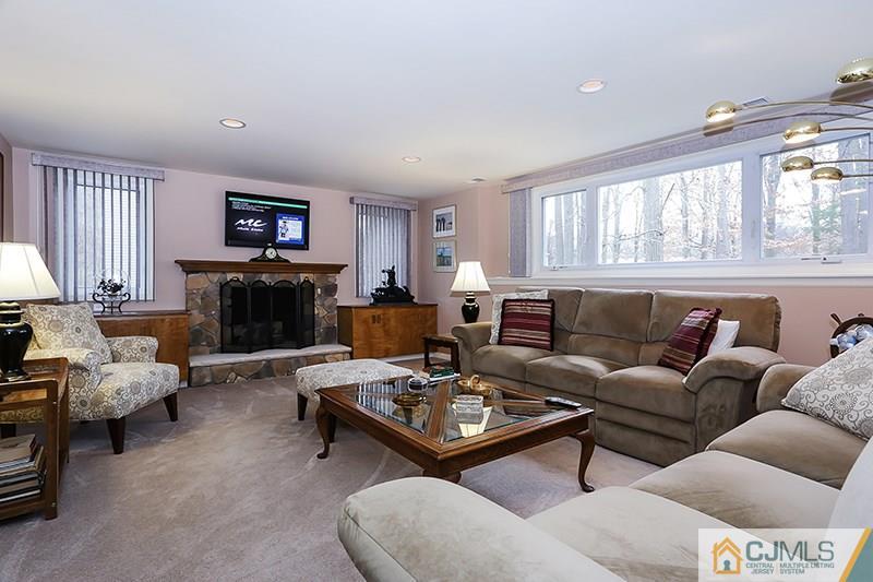 29 Nottingham Road Edison, NJ 08820 - Photo 8 of 18 a living room with furniture a fireplace and a large window