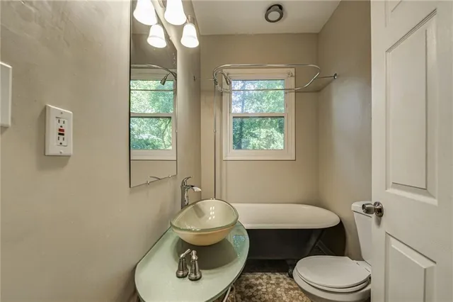 a view of a house with a yard and a porch