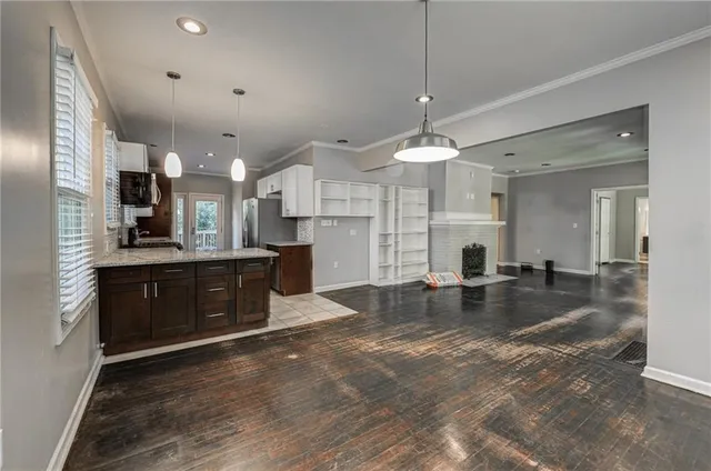 a large kitchen with stainless steel appliances granite countertop a sink stove and cabinets