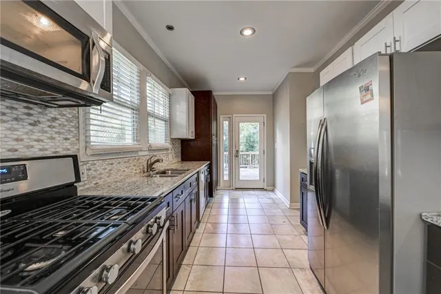 a bedroom with a bed and a large mirror with a chandelier