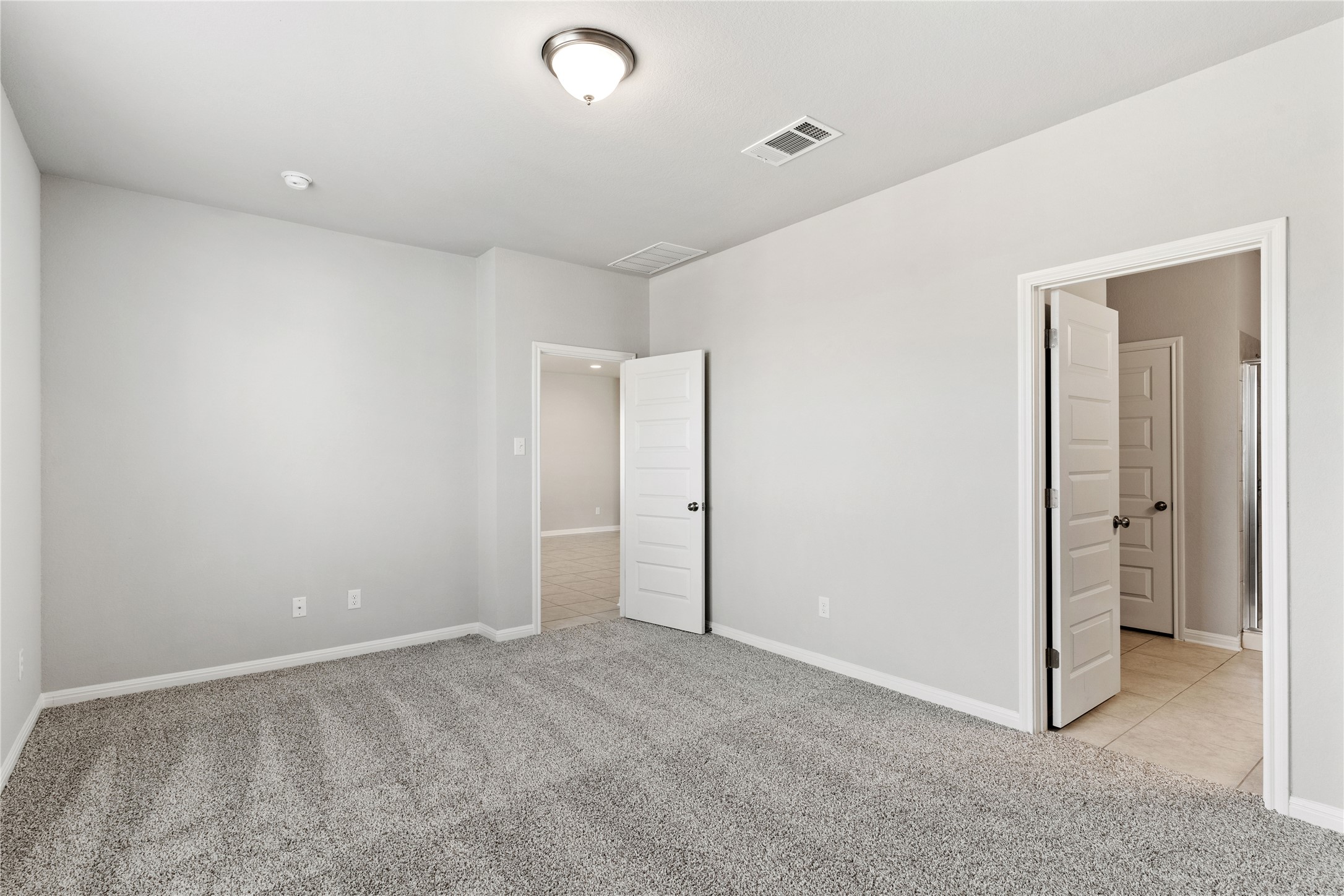 313 Mclintock Road Jarrell, TX 76537 - Photo 14 of 17 A spacious, neutral-toned room awaits personalization with plush carpeting and natural light.
