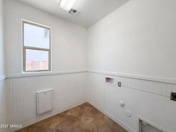 a view of storage and utility room with closet