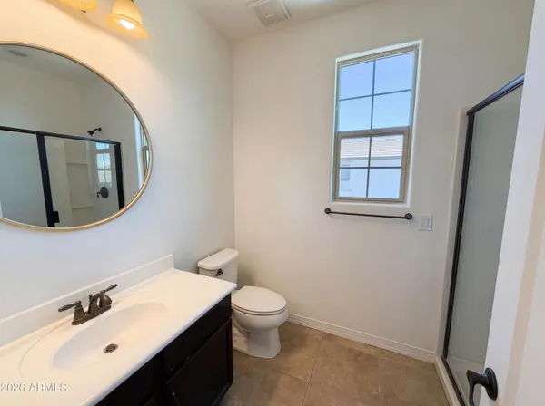a bathroom with a sink mirror and toilet