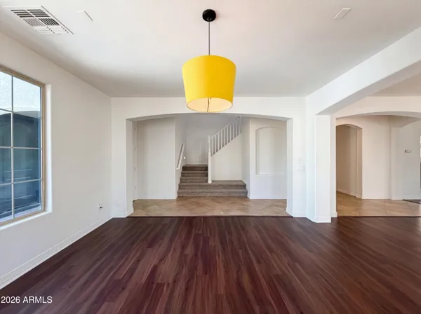 a view of a room with wooden floor and a chandelier