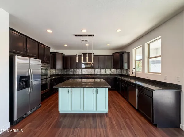 a kitchen with a sink stainless steel appliances and cabinets
