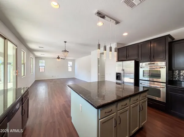 a kitchen with stainless steel appliances granite countertop a sink refrigerator and microwave