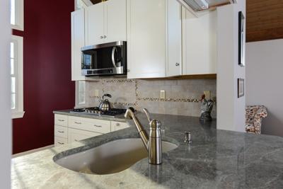 228 Huckins Neck Road Centerville, MA 02601 - Photo 12 of 19 a kitchen with a stove and a sink