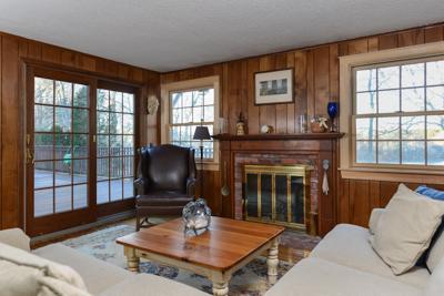 228 Huckins Neck Road Centerville, MA 02601 - Photo 14 of 19 a living room with furniture a fireplace and a floor to ceiling window