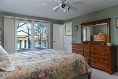 228 Huckins Neck Road Centerville, MA 02601 - Photo 15 of 19 a bedroom with a large bed and a large window