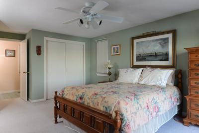 228 Huckins Neck Road Centerville, MA 02601 - Photo 16 of 19 a bedroom with a bed and a chandelier