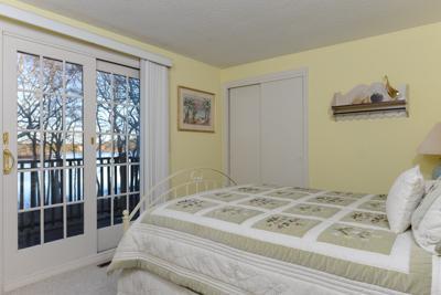 228 Huckins Neck Road Centerville, MA 02601 - Photo 17 of 19 a bedroom with a bed and a window