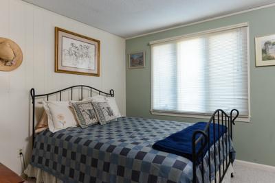 228 Huckins Neck Road Centerville, MA 02601 - Photo 18 of 19 a bedroom with a bed a window and painting on the wall