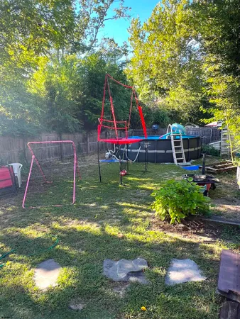 a view of a backyard with swimming pool
