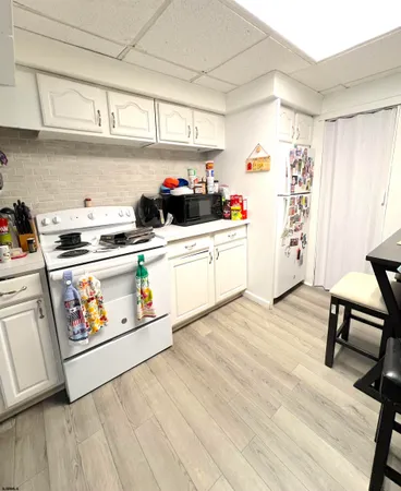 a kitchen with stainless steel appliances a stove a sink and a refrigerator