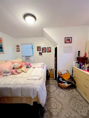a bedroom with a bed and dresser