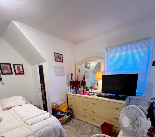 a bedroom with furniture and a flat screen tv