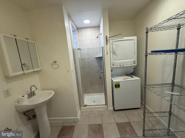 a bathroom with a sink a mirror and shower