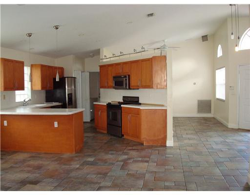 11030 Baybreeze Way Boca Raton, FL 33428 - Photo 2 of 11 a large kitchen with stainless steel appliances granite countertop a stove a sink and a refrigerator