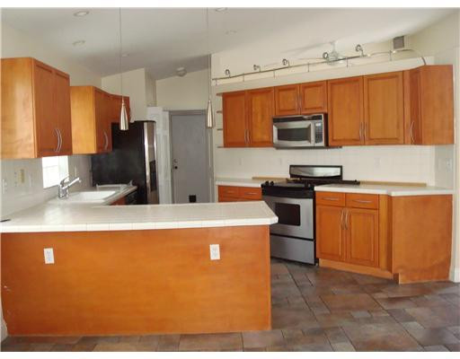 11030 Baybreeze Way Boca Raton, FL 33428 - Photo 3 of 11 a kitchen with stainless steel appliances a refrigerator a stove a sink and a microwave