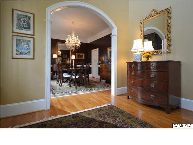 3072 Darby Road, Unit P2A 31 Keswick, VA 22947 - Photo 4 of 40 An elegant double archway w/curved ceiling frames the opening to the family room w/its stunning views, issuing an alluring invitation to enter into the heart of the home. The broad staircase & banister frame the foyer, creating a sense of "place".