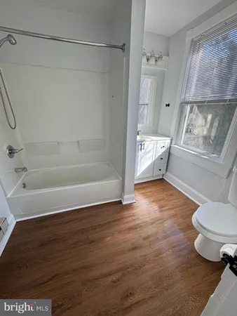 a bathroom with a toilet and a tub