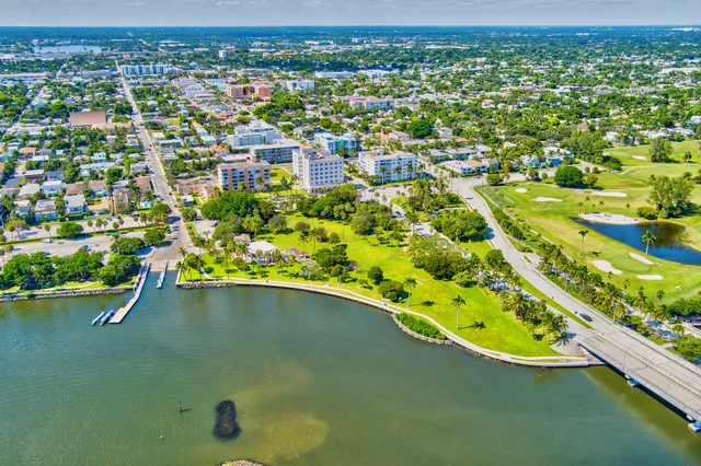 an aerial view of residential houses with outdoor space and street view