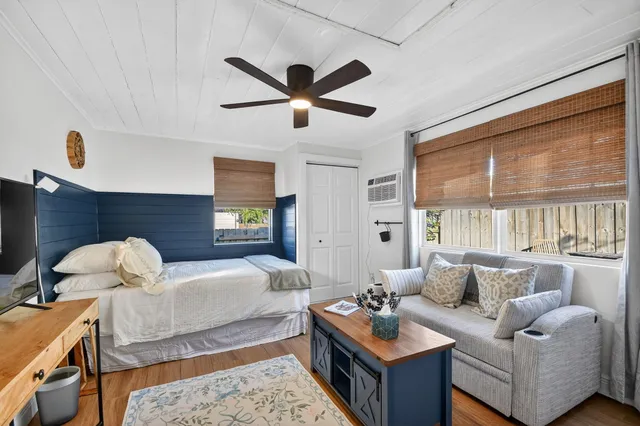 a living room with furniture ceiling fan and a window