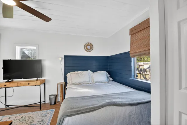 a bedroom with a bed and a flat screen tv