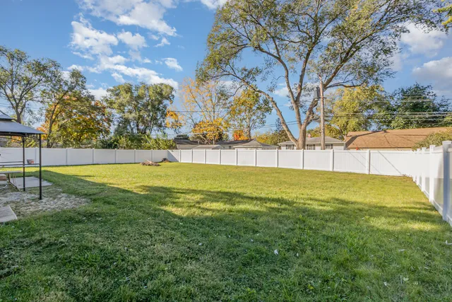 a view of yard with swimming pool and trees