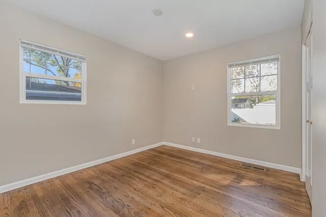 a view of room with window and wooden floor