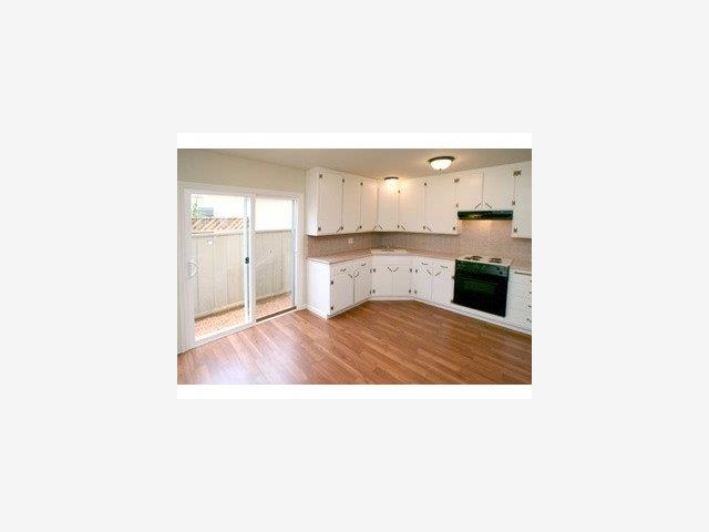 4550 Opal Street Capitola, CA 95010 - Photo 2 of 8 a open kitchen with a sink and cabinets