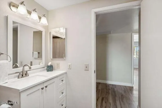 a bathroom with a sink a light fixture a vanity and a mirror