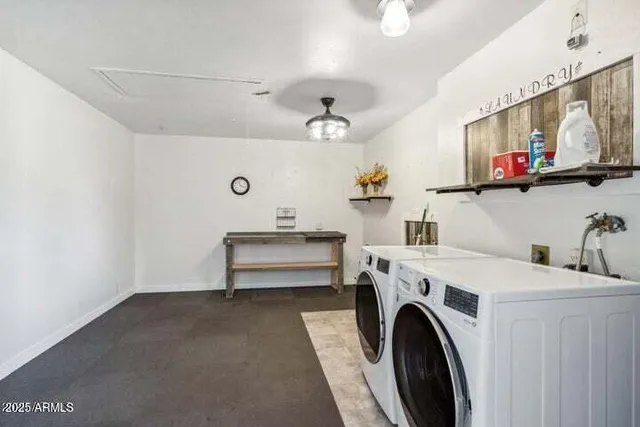a view of storage and utility room with washer and dryer