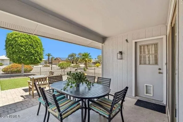 a view of a dining room with furniture and a potted plant