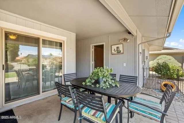 a balcony with furniture and a potted plant