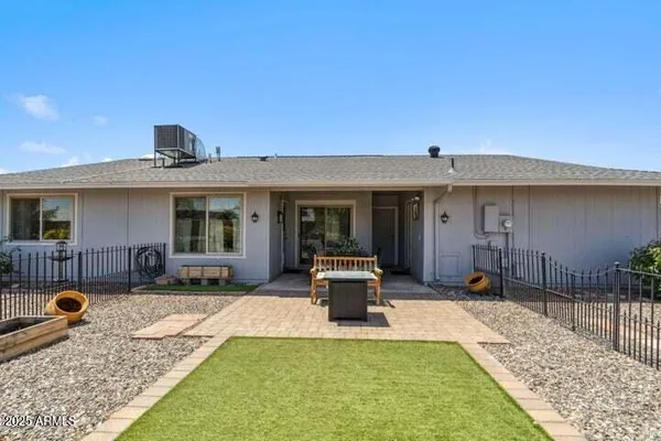 a view of a house with backyard porch and sitting area