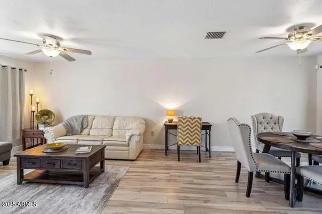 a living room with furniture and wooden floor