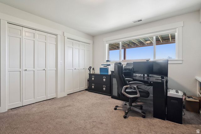 550 Pine Canyon Road Midway, UT 84049 - Photo 29 of 44 Recessed window with white trim, two white bi-fold closet doors, and light-colored carpeting