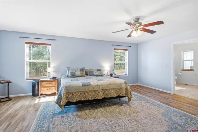 a bedroom with a bed a dresser and a window