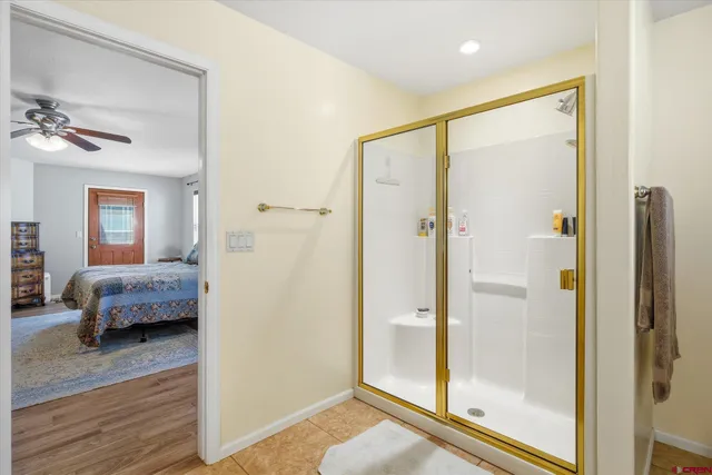 a bedroom with a bed wooden floor and a chandelier