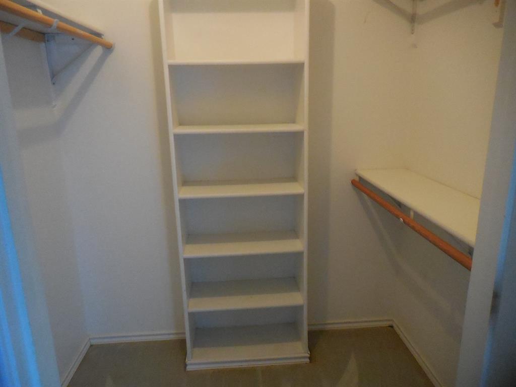 5335 Highway 11 Commerce, TX 75428 - Photo 11 of 16 a view of walk in closet with empty racks