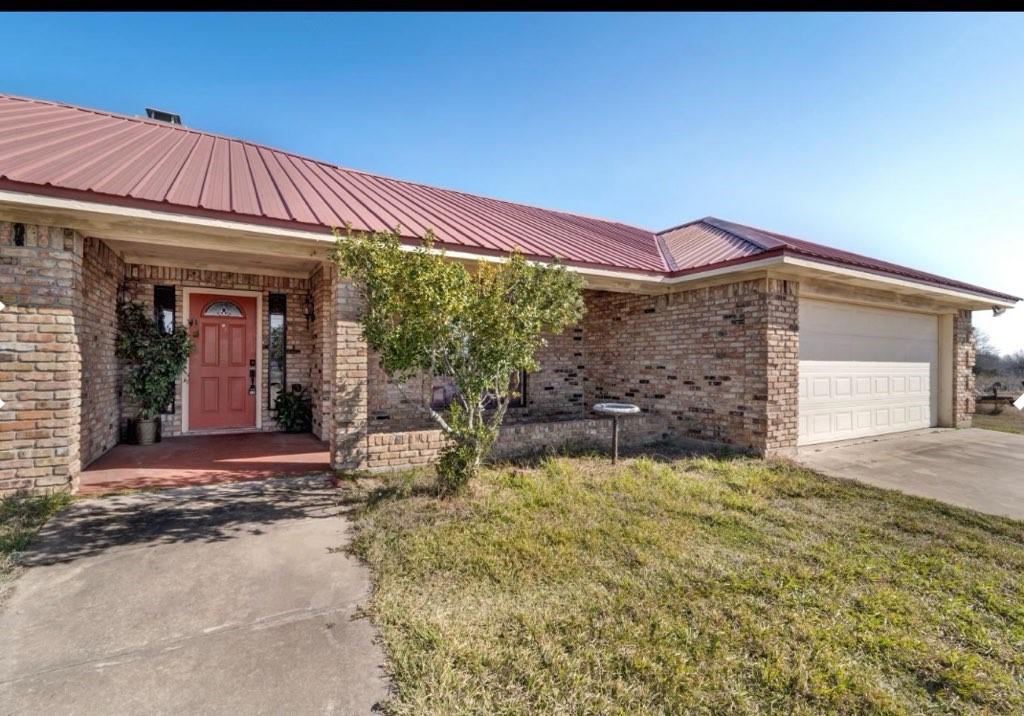 5335 Highway 11 Commerce, TX 75428 - Photo 2 of 16 a view of a house with a small yard and plants