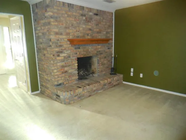 a view of empty room with a fireplace