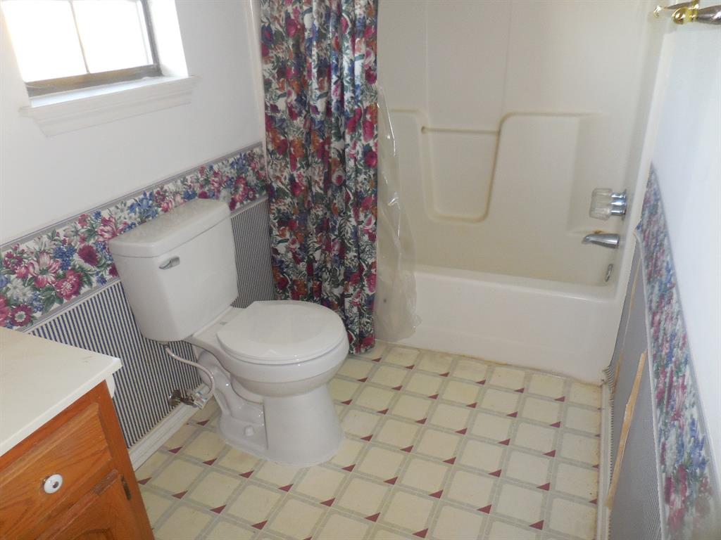 5335 Highway 11 Commerce, TX 75428 - Photo 10 of 16 a bathroom with a toilet and a shower
