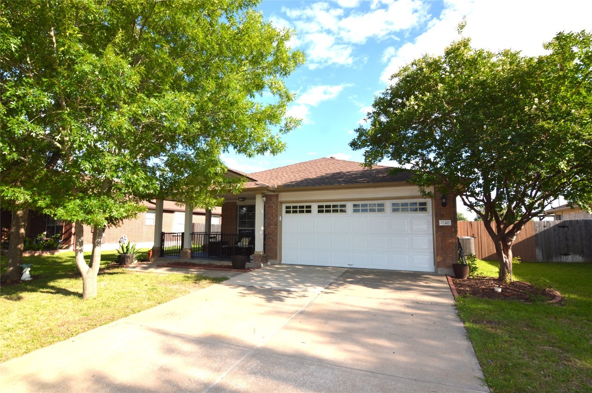 2140 Pearson Way Round Rock, TX 78665 - Photo 1 of 1 a front view of house with yard and trees