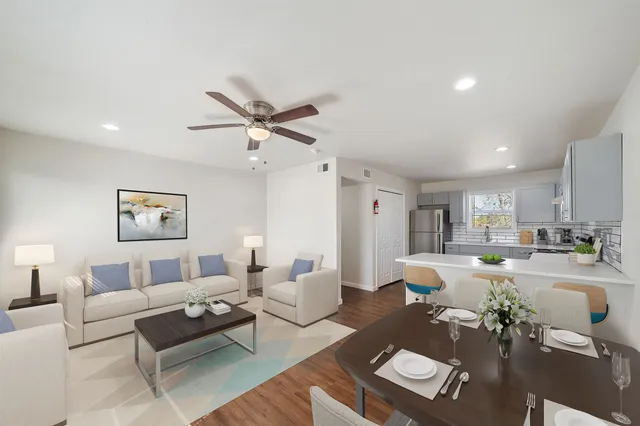 a living room with furniture and a wooden floor