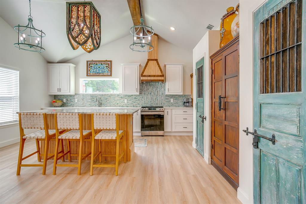 508 South Elm Street Weatherford, TX 76086 - Photo 15 of 40 a kitchen with stainless steel appliances granite countertop a stove and a wooden floors