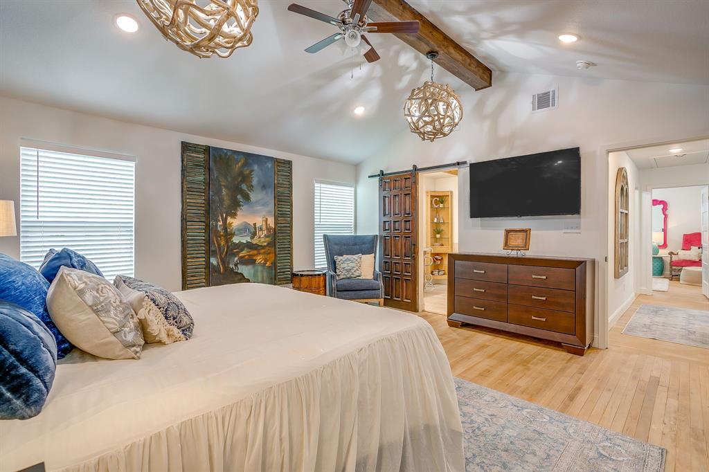 508 South Elm Street Weatherford, TX 76086 - Photo 19 of 40 a bedroom with a bed and a flat screen tv